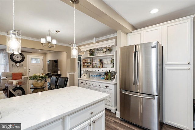 4406 Furley Ave, Baltimore, MD 21206 - kitchen with freestanding refrigerator, ornamental molding, white cabinets, light stone counters, and dark wood finished floors