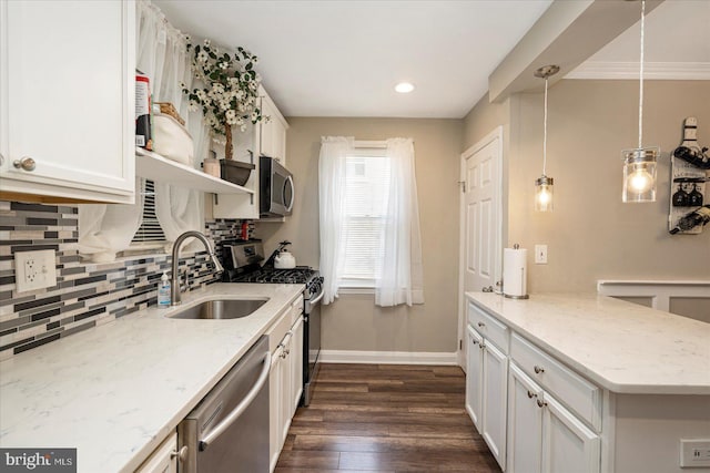 4406 Furley Ave, Baltimore, MD 21206 - kitchen with a sink, stainless steel appliances, decorative backsplash, dark wood-style flooring, and a peninsula