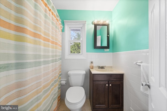 428 Hampshire Dr, Broomall, PA 19008 - full bath featuring tile walls, vanity, toilet, a wainscoted wall, and tile patterned floors