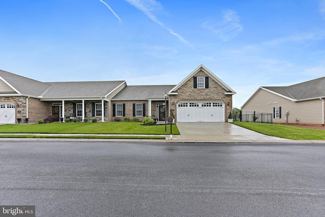 61 Stoners Cir, Littlestown, PA 17340 - view of front facade with concrete driveway, stone siding, brick siding, and roof with shingles