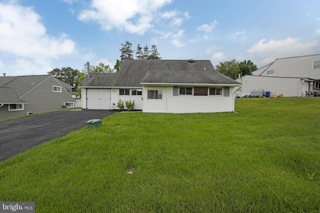21 Hillside Rd, Levittown, PA 19056 - view of front facade with an attached garage, asphalt driveway, and a front lawn