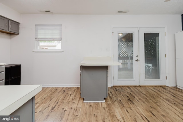 103 Stadium Cir, Inwood, WV 25428 - kitchen featuring light countertops, light wood-type flooring, french doors, and baseboards