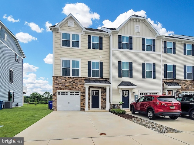 118 Fletcher Cir, Middletown, DE 19709 - view of property with concrete driveway, a garage, stone siding, and board and batten siding