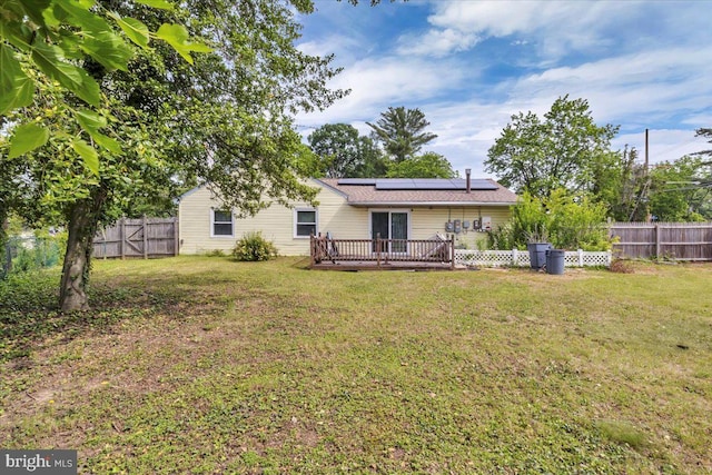 96 Messenger Ln, Willingboro, NJ 08046 - rear view of house featuring roof mounted solar panels and a wooden deck