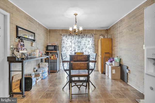 96 Messenger Ln, Willingboro, NJ 08046 - dining space with a chandelier and brick wall