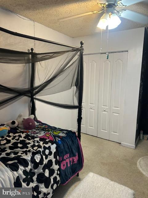 6708 Pauline Ct, Bryans Road, MD 20616 - bedroom with light carpet, ceiling fan, a closet, and a textured ceiling