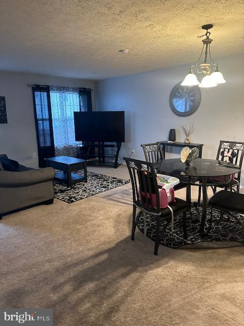 6708 Pauline Ct, Bryans Road, MD 20616 - dining area with carpet, a textured ceiling, and a chandelier