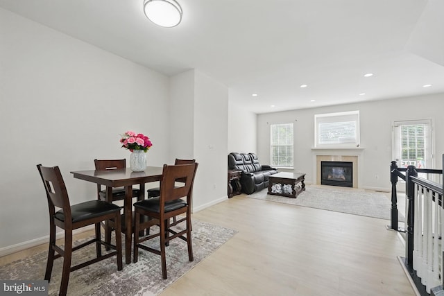 21748 Kings Crossing Ter, Ashburn, VA 20147 - dining room with wood finished floors, plenty of natural light, a fireplace with flush hearth, and recessed lighting