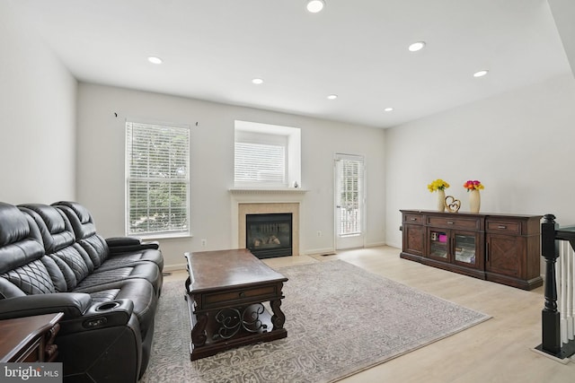 21748 Kings Crossing Ter, Ashburn, VA 20147 - living area featuring wood finished floors, recessed lighting, a fireplace with flush hearth, and baseboards