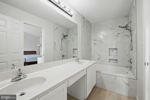 21748 Kings Crossing Ter, Ashburn, VA 20147 - bathroom with ensuite bathroom, double vanity, a combined bath / shower with marble appearance, and wood finished floors