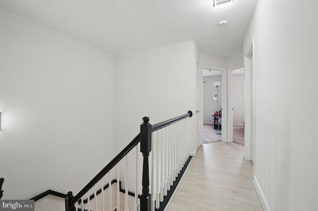 21748 Kings Crossing Ter, Ashburn, VA 20147 - hall featuring light wood-style floors and an upstairs landing