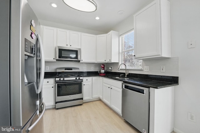 21748 Kings Crossing Ter, Ashburn, VA 20147 - kitchen with appliances with stainless steel finishes, a sink, white cabinetry, decorative backsplash, and recessed lighting