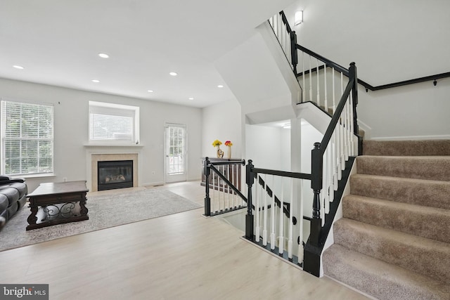 21748 Kings Crossing Ter, Ashburn, VA 20147 - stairs featuring wood finished floors, recessed lighting, a fireplace with flush hearth, and baseboards