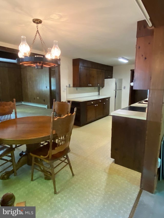 724 Ocean Ave, Galloway, NJ 08205 - dining room featuring a chandelier, wood walls, and baseboard heating