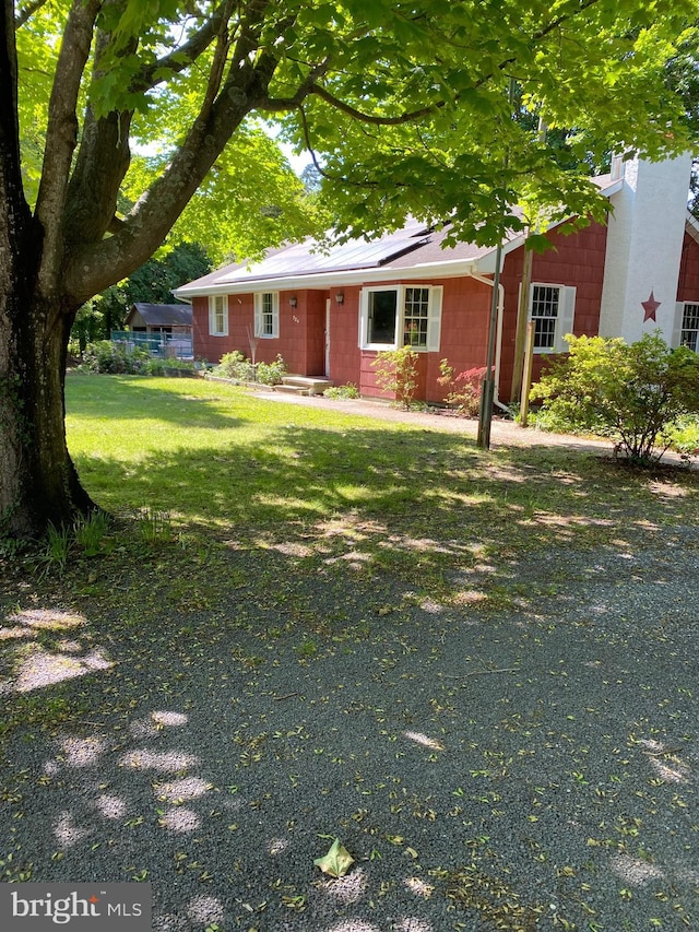 724 Ocean Ave, Galloway, NJ 08205 - view of front facade featuring a front yard, concrete block siding, and solar panels