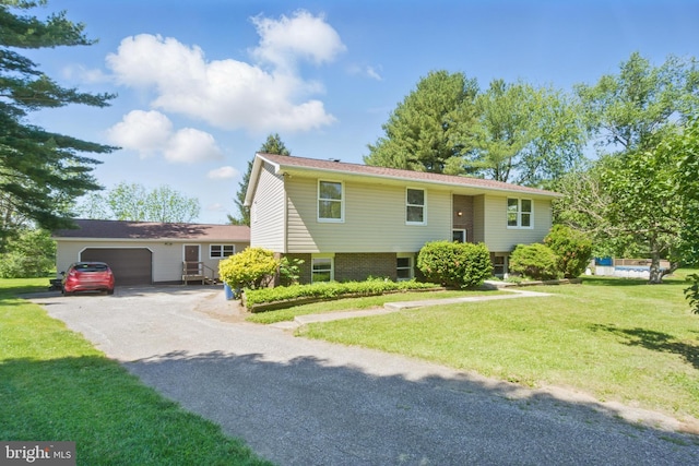 4202 Wolf Ct, Hampstead, MD 21074 - view of front of property featuring an attached garage, a front lawn, and asphalt driveway