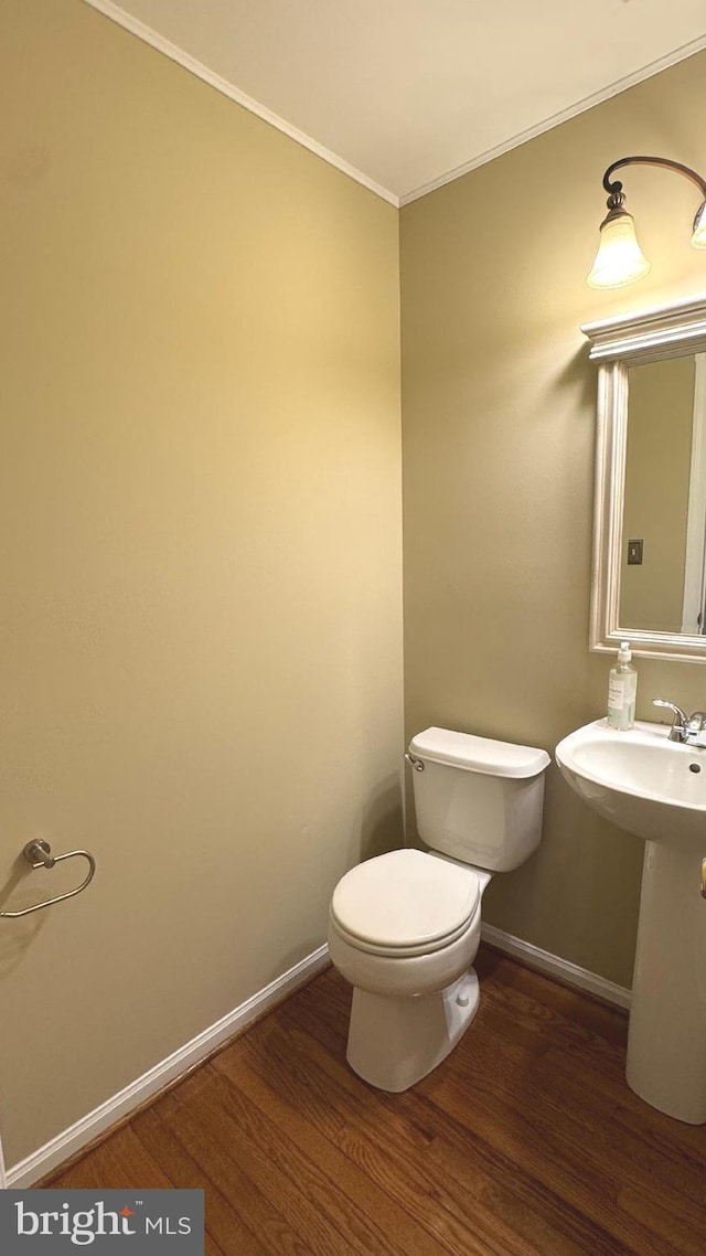 9 Whirlaway Dr, Bear, DE 19701 - bathroom featuring wood finished floors, toilet, crown molding, and baseboards