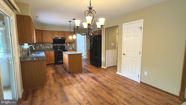 9 Whirlaway Dr, Bear, DE 19701 - kitchen with black appliances, a center island, range hood, and dark wood finished floors