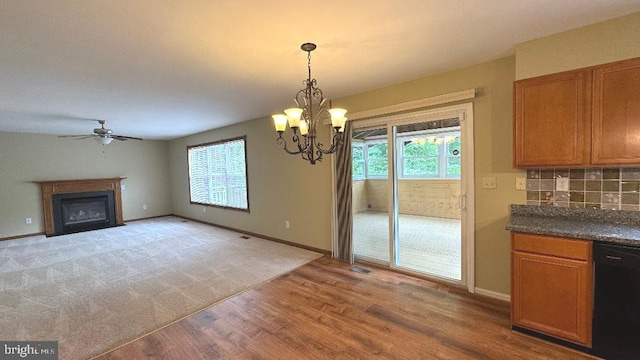 9 Whirlaway Dr, Bear, DE 19701 - unfurnished dining area with light wood-type flooring, a ceiling fan, a fireplace, a chandelier, and baseboards