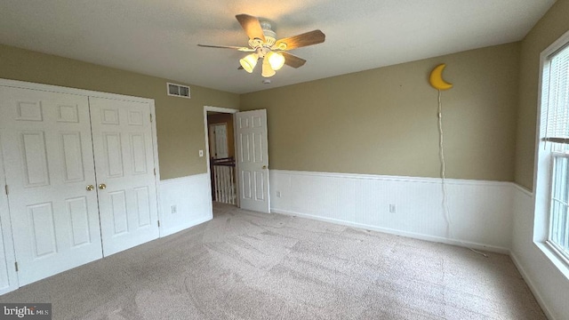 9 Whirlaway Dr, Bear, DE 19701 - unfurnished bedroom featuring carpet floors, a closet, wainscoting, and ceiling fan