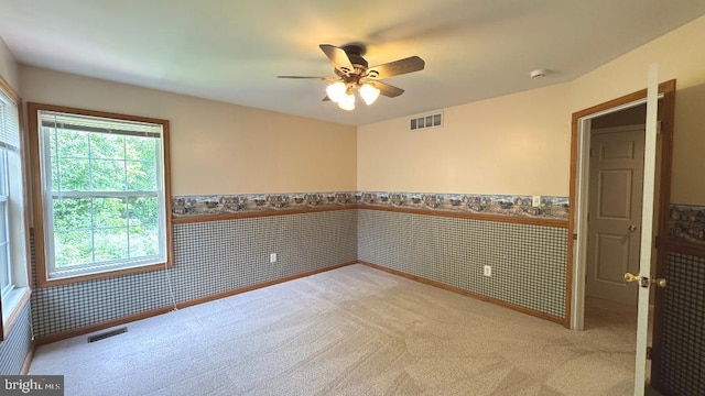 9 Whirlaway Dr, Bear, DE 19701 - spare room featuring light carpet, ceiling fan, and wainscoting