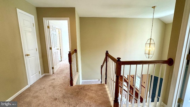 9 Whirlaway Dr, Bear, DE 19701 - hall with an upstairs landing, carpet flooring, and a chandelier