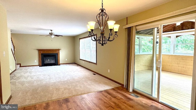 9 Whirlaway Dr, Bear, DE 19701 - unfurnished living room with a glass covered fireplace, ceiling fan, wood finished floors, and carpet