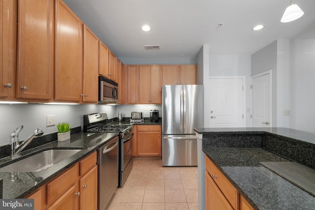 2665 Prosperity Ave Unit 109, Fairfax, VA 22031 - kitchen featuring stainless steel appliances, a sink, dark stone counters, light tile patterned flooring, and recessed lighting