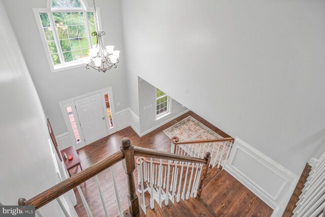 4904 Charmed Ct, Woodbridge, VA 22192 - foyer entrance with a chandelier, wood finished floors, plenty of natural light, and a high ceiling
