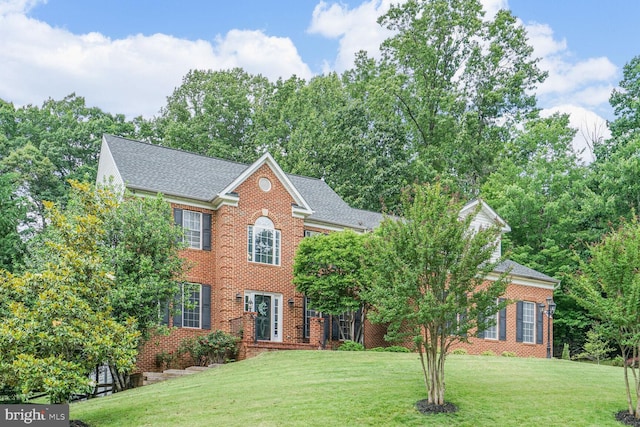 4904 Charmed Ct, Woodbridge, VA 22192 - colonial-style house featuring a front yard, brick siding, and a shingled roof