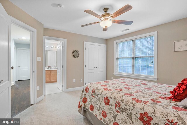 4904 Charmed Ct, Woodbridge, VA 22192 - bedroom with light carpet, baseboards, connected bathroom, ceiling fan, and a closet