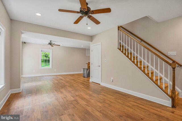 4904 Charmed Ct, Woodbridge, VA 22192 - unfurnished living room featuring ceiling fan, wood-type flooring, stairs, baseboards, and recessed lighting