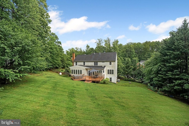 4904 Charmed Ct, Woodbridge, VA 22192 - rear view of property with a deck, a yard, a chimney, and a wooded view