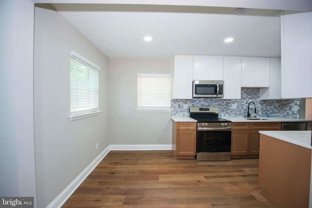 1407 Ruatan St, Hyattsville, MD 20783 - kitchen with stainless steel appliances, a sink, dark wood-type flooring, decorative backsplash, and recessed lighting