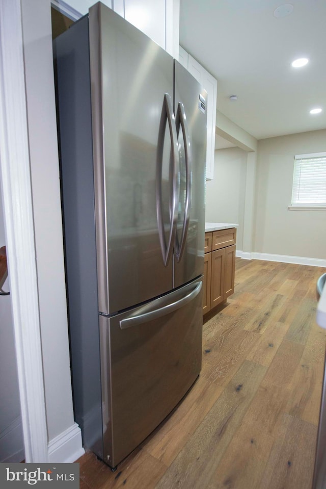 1407 Ruatan St, Hyattsville, MD 20783 - kitchen view of freestanding refrigerator, light wood-type flooring, baseboards, recessed lighting, and light countertops