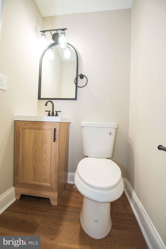 1407 Ruatan St, Hyattsville, MD 20783 - bathroom featuring vanity, baseboards, toilet, and wood finished floors
