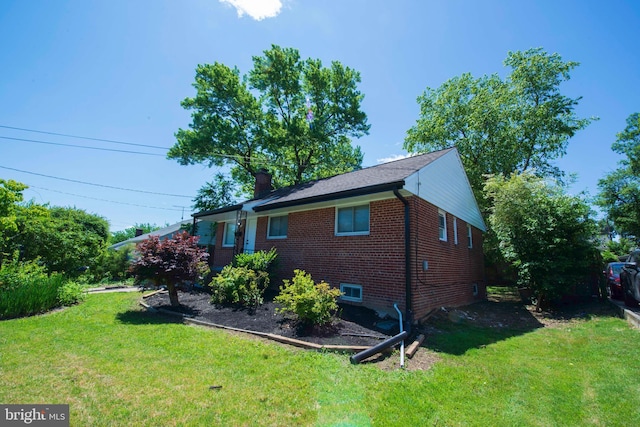 1407 Ruatan St, Hyattsville, MD 20783 - view of home's exterior with brick siding, a yard, and a chimney