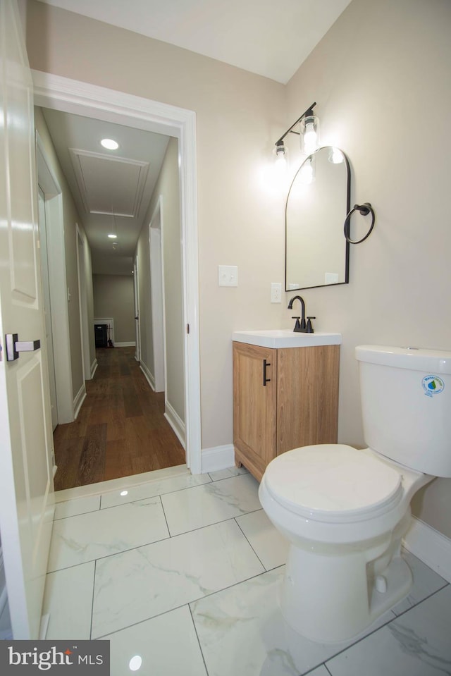 1407 Ruatan St, Hyattsville, MD 20783 - bathroom featuring toilet, vanity, marble finish floors, and baseboards