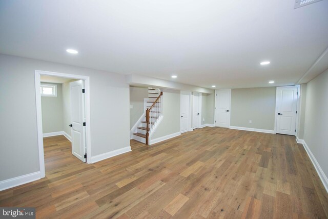 1407 Ruatan St, Hyattsville, MD 20783 - basement featuring stairway, recessed lighting, wood finished floors, and baseboards