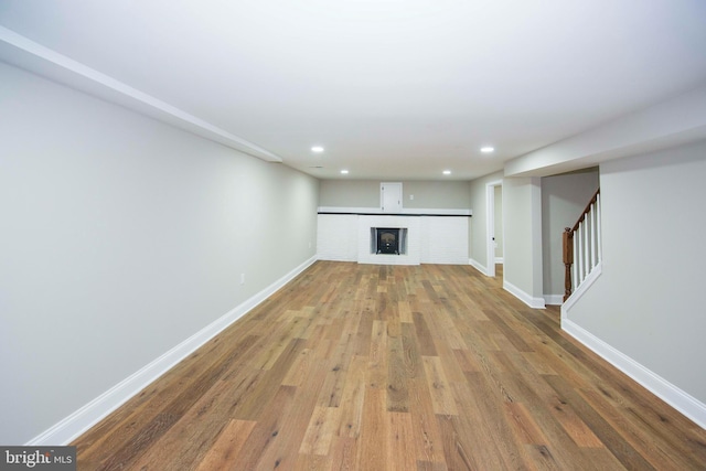 1407 Ruatan St, Hyattsville, MD 20783 - unfurnished living room featuring wood finished floors, baseboards, recessed lighting, and stairway