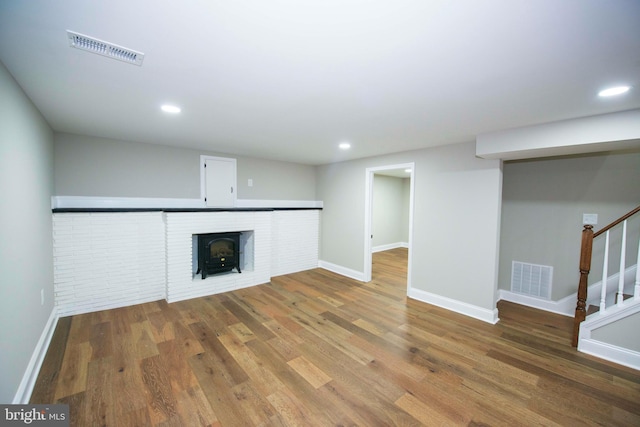 1407 Ruatan St, Hyattsville, MD 20783 - unfurnished living room featuring wood finished floors, stairs, baseboards, and recessed lighting