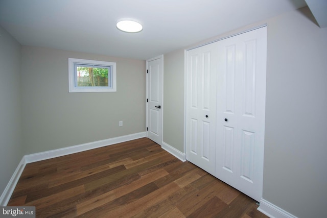 1407 Ruatan St, Hyattsville, MD 20783 - unfurnished bedroom featuring dark wood finished floors, baseboards, and a closet