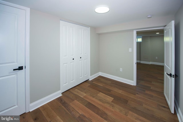 1407 Ruatan St, Hyattsville, MD 20783 - unfurnished bedroom featuring dark wood-style flooring, baseboards, and a closet