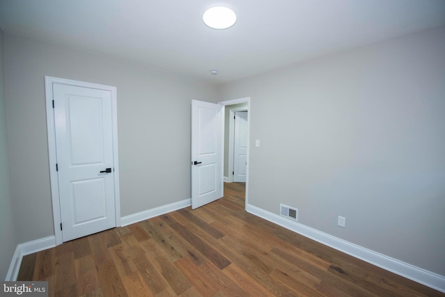 1407 Ruatan St, Hyattsville, MD 20783 - unfurnished bedroom featuring baseboards and wood finished floors