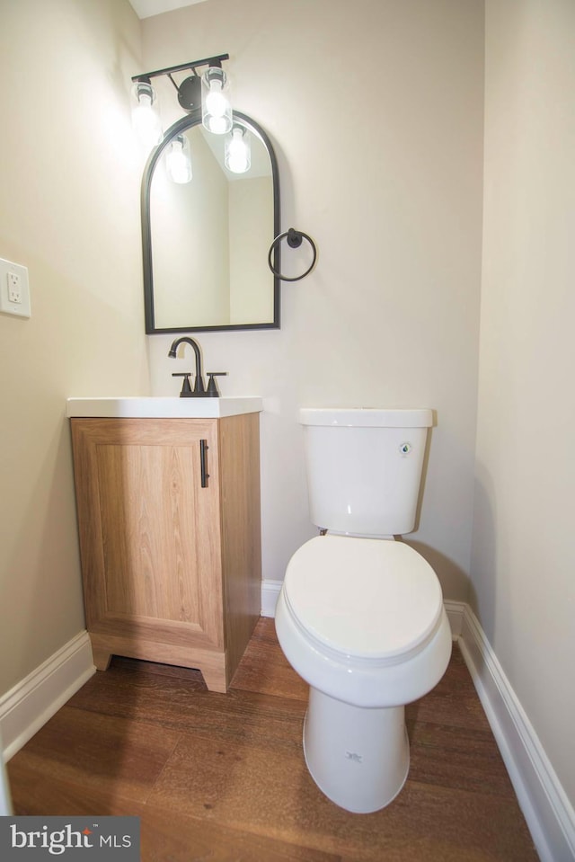 1407 Ruatan St, Hyattsville, MD 20783 - bathroom with baseboards, vanity, toilet, and wood finished floors