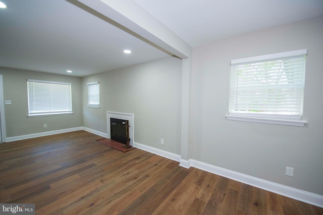 1407 Ruatan St, Hyattsville, MD 20783 - empty room featuring baseboards, dark wood-style floors, recessed lighting, and a glass covered fireplace