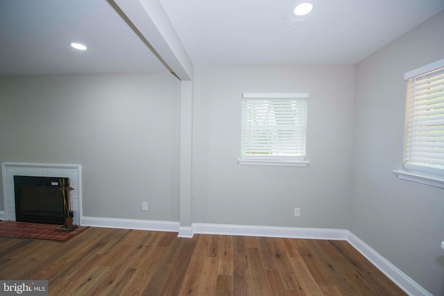 1407 Ruatan St, Hyattsville, MD 20783 - unfurnished living room with wood finished floors, baseboards, a brick fireplace, and recessed lighting