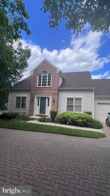2409 Bear Den Rd, Frederick, MD 21701 - traditional-style house featuring decorative driveway and an attached garage