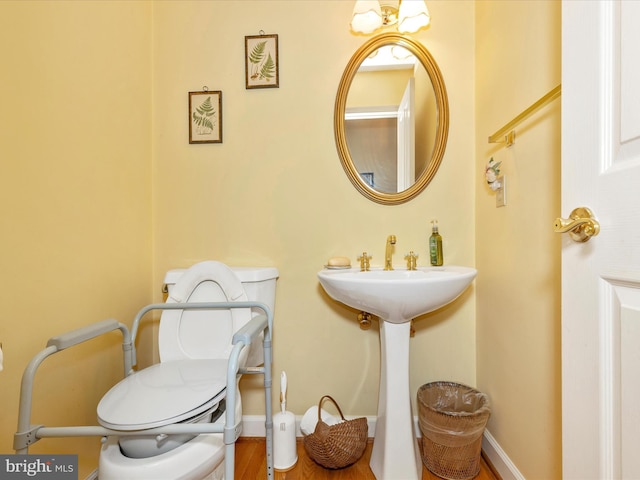 2409 Bear Den Rd, Frederick, MD 21701 - bathroom featuring toilet, baseboards, and wood finished floors