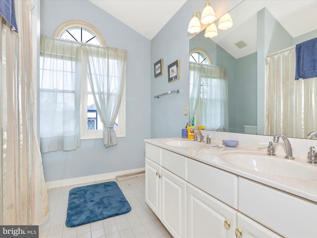 2409 Bear Den Rd, Frederick, MD 21701 - full bath featuring lofted ceiling, double vanity, plenty of natural light, tile patterned flooring, and baseboards